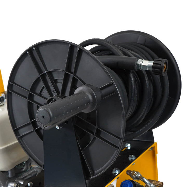 Close up of black hose reel belonging to yellow and black pressure washer by brand SkyVacm model SlipStream, and engine Honda.