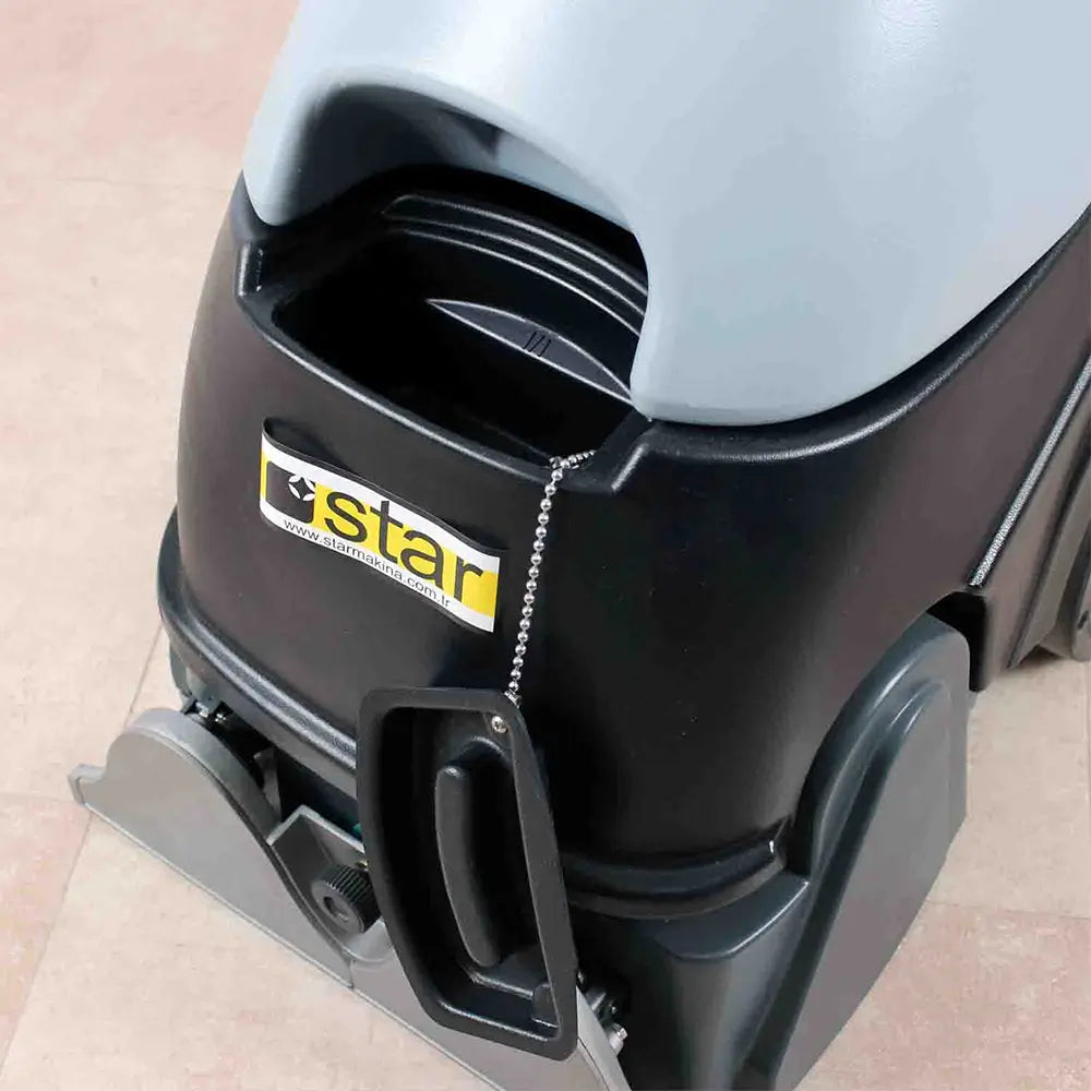 Closeup view of sweeper to  grey carpet cleaner machine by brand Star, model Combi Compact with opened lid.